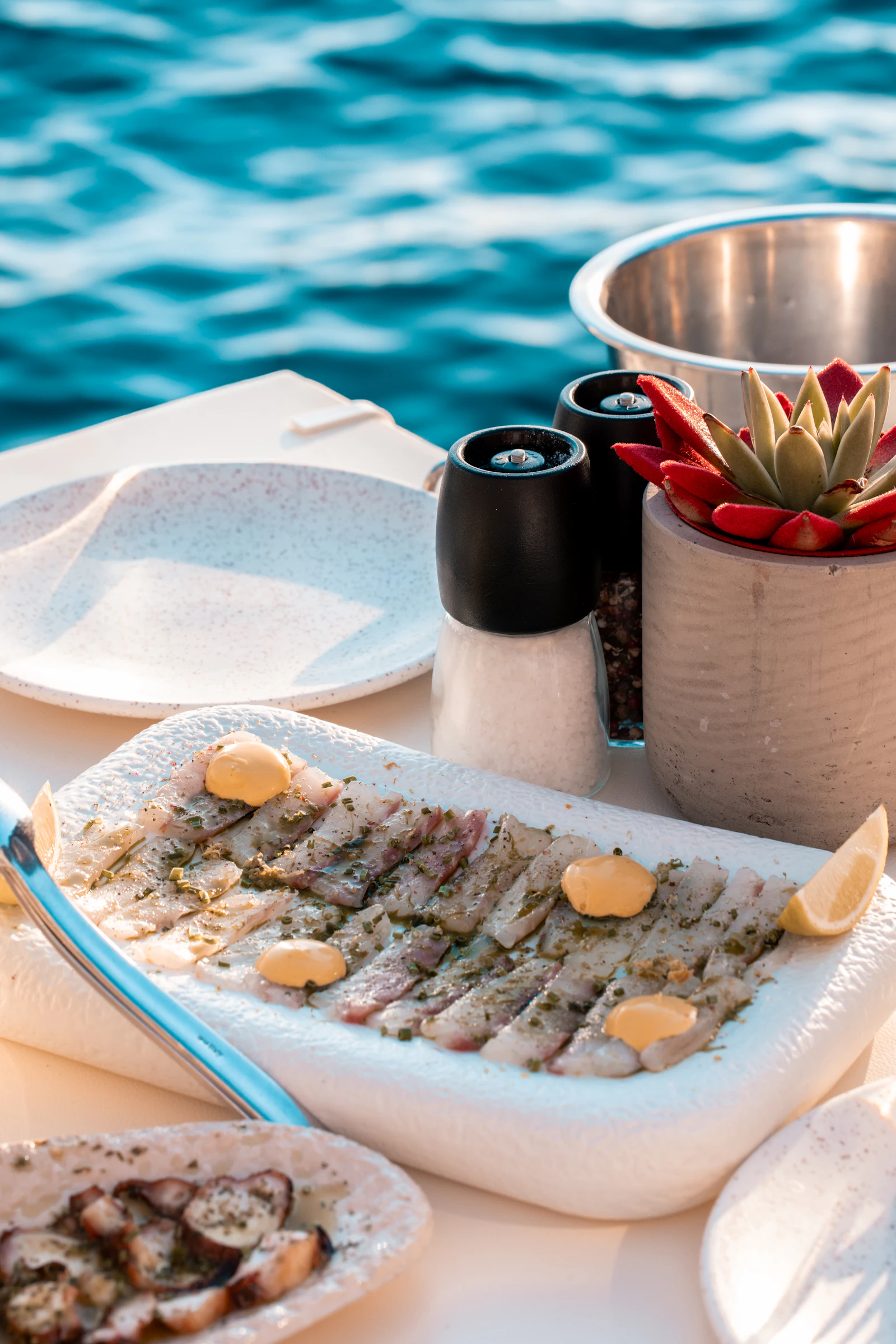 Raw seafood carpaccio served on a boat